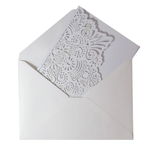 Elegant laser-cut floral wedding invitation set with intricate hollow design and envelope