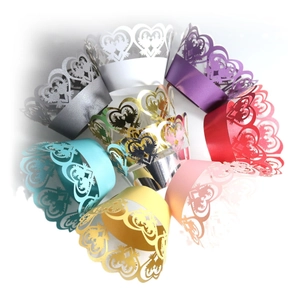 Laser cut heart shaped paper cupcake wrappers in various pearlescent colors for weddings