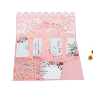 Pink laser-cut 3D wedding invitation featuring a bride and groom kissing silhouette