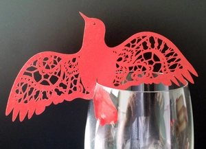 Laser cut red bird paper place cards for wine glass decoration at weddings and parties