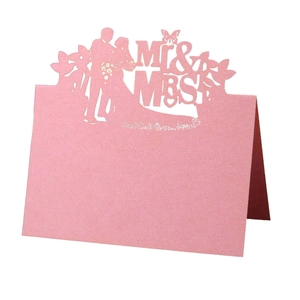 Pink pearlescent laser cut wedding table cards with Mr & Mrs groom and bride design