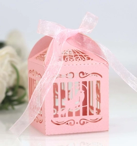 Laser cut birdcage wedding favor box in pink pearl paper with ribbon bow decoration