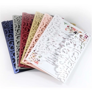 Laser cut wedding invitations in navy blue and assorted colors with floral insert card