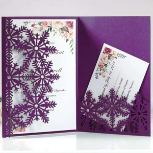 Elegant laser-cut snowflake wedding invitation set in dark purple with floral details