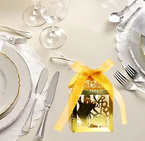 Golden laser-cut Halloween favor box featuring ghost and BOO patterns with ribbon