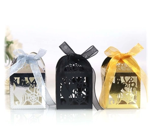 Laser-cut Halloween gift boxes with ghost and spider web patterns in gold, silver, and black