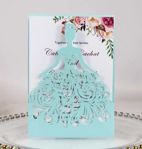 Detail of laser-cut wedding invitation featuring a blue princess silhouette and floral card