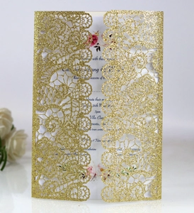 Detailed laser-cut lace texture on gold glitter wedding invitation with floral insert