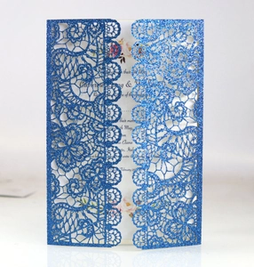 Detail of laser-cut royal blue glitter lace wedding invitation with floral insert card