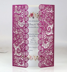 Detail showing laser-cut rose red glitter wedding invitation with floral hollow design