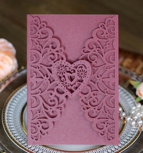 Detailed laser-cut heart invitation card in dusty rose with elegant pearl texture
