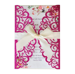 Fuchsia laser-cut wedding invitation with glitter finish and off-white satin ribbon bow