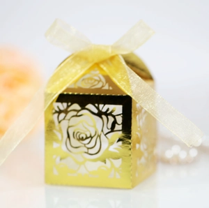 Close-up of golden hollow rose candy box with delicate laser-cut patterns and ribbon