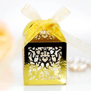 Elegant gold laser cut hollow candy box with matching ribbon bow for wedding parties