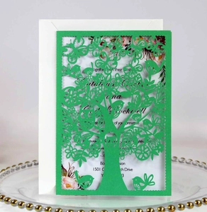 Detailed laser-cut tree and bird invitation card set with bright green shell and white envelope