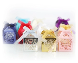 Laser-cut hollow floral party favor boxes with organza ribbons for wedding candy packaging