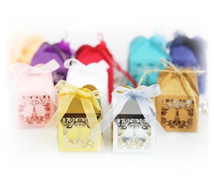Laser-cut Christmas candy gift boxes with tree and bird patterns and silk ribbon bows
