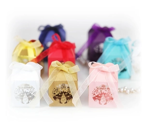 Laser-cut Christmas tree candy boxes in multiple colors with matching silk ribbons