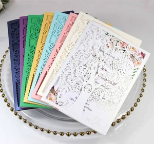 Close-up of laser-cut tree design wedding invitations in various vibrant colors