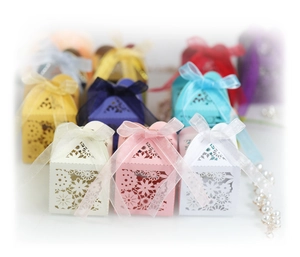 Laser-cut floral paper favor boxes with satin ribbons for weddings and parties