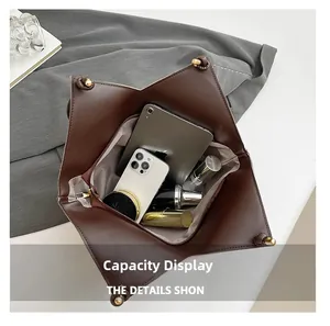 Macro view of the spacious inner capacity of the dark brown leather tote with daily essentials