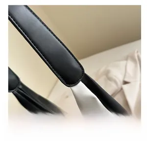 Close-up of high-quality stitching and shoulder strap connection on bicolor tote bag