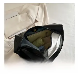 Macro view of spacious interior storage of the black and white faux leather tote bag