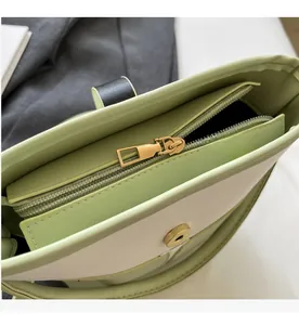 Detail of smooth gold zipper and magnetic snap closure on patchwork bucket bag