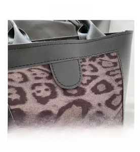 Close-up of leopard print suede and black leather stitching detail on this fashion tote bag