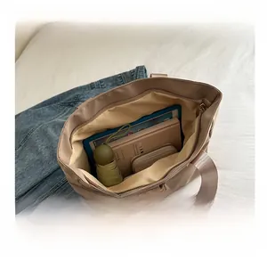 Detailed interior view of a beige tote bag showing high capacity for tablets and daily items