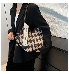 Close-up of vintage argyle tote bag with V-shaped opening and woven logo strap