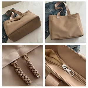 Detailed close-up of khaki tote bag with woven rope zipper pull and durable stitching