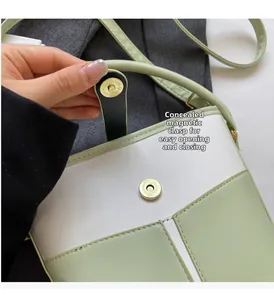 Detail of the invisible magnetic buckle closure on a two-tone mini bucket bag