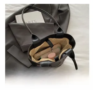 Interior view of leopard print bucket bag showing spacious storage for phone and wallet