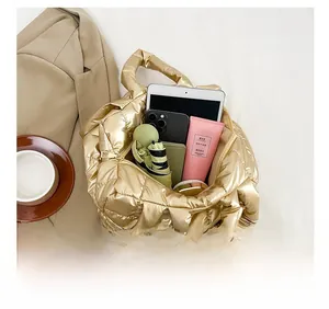 Top view of spacious gold quilted tote bag showing daily essentials and tablet