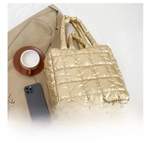 Detail view of the quilted texture and metallic gold fabric of this puffer tote bag