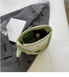 Detailed view of spacious interior and magnetic closure on colorblock bucket bag