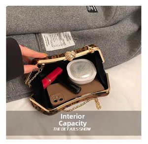 Détail de la capacité de la pochette léopard montrant smartphone, rouge à lèvres et chaîne