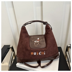 Detail of dark brown tote bag with Mutehi embroidery and cute dog pattern flap