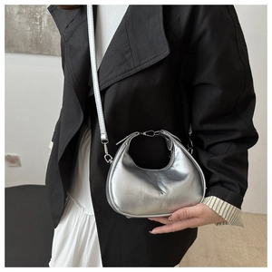 Detail of silver metallic hobo bag with wrinkled texture and brand embossing