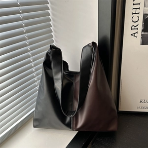 Retro fashion tote bag with black and brown leather patchwork and wide shoulder strap