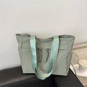 Minimalist light green large tote bag for women with wide webbing straps and side pockets