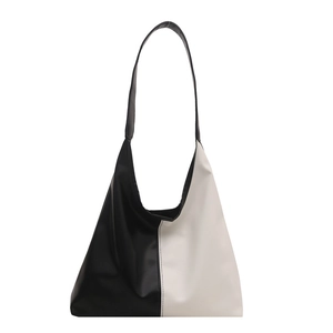 Minimalist black and white color-block tote bag with wide strap for stylish daily commuting