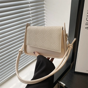 Minimalist beige crossbody bag with woven texture flap and stylish knot shoulder strap