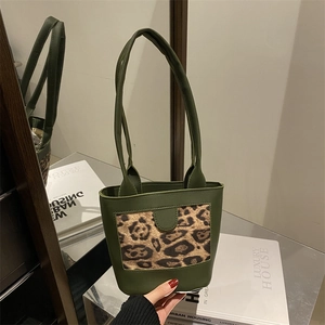 Fashionable dark green leopard print bucket bag with dual straps for shoulder or hand carry