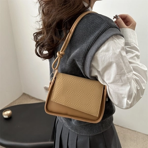Minimalist khaki leather shoulder bag with woven flap and stylish knotted strap detail