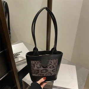 Minimalist leopard print bucket bag with black leather and slim handles for women