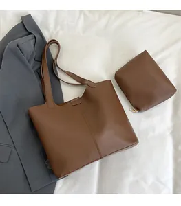 Brown faux leather tote bag set with matching zippered pouch on white background