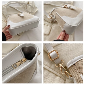 Detail view of contrast stitch shoulder bag with canvas texture and gold hardware hooks