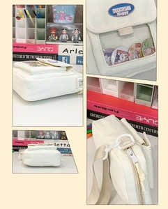 Détail du sac ita blanc avec fenêtre transparente et badges de dessins animés